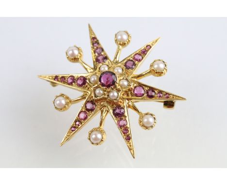 9ct gold hallmarked ruby and pearl star brooch. The brooch being set with a round mixed cut ruby to the centre, surrounded by