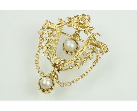 14ct gold and cultured pearl floral garland brooch. The brooch in the form of a U shaped foliate garland with half pearls sus