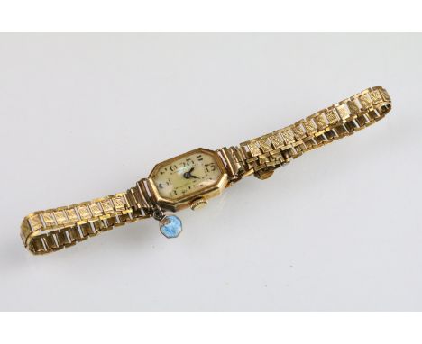 18ct gold wrist watch having a mother of pearl face with arabic numerals to the chapter ring. Inner case import marked 1929. 