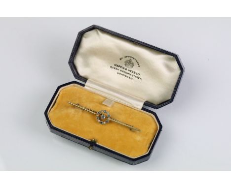 15ct gold aquamarine and pearl bar brooch. The brooch having a central millegrain set aquamarine with a halo of further aquam