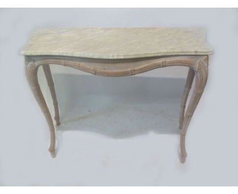 A Serpentine Console Table, with a variegated marble top above a simulated bamboo stand