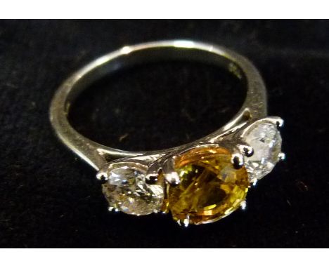 An 18ct. White Gold Yellow Sapphire Ring and Diamond Ring, set with central yellow sapphire and two diamonds, sapphire 1.75ct