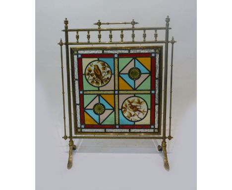 A Late Victorian or Early Edwardian Brass Fire Screen, with a stain glass panel