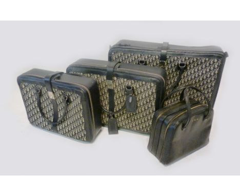 A Set of Three Pieces of Luggage by Christian Dior, together with another small item of hand luggage