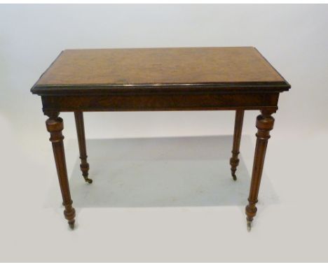 A Victorian Burr Walnut and Ebonised Inlaid Rectangular Card Table, the hinged top raised upon turned tapering fluted legs wi