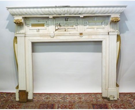 A 19th Century Large Painted Fire Surround, the moulded top above three moulded panels flanked by carved scrolls with gilded 