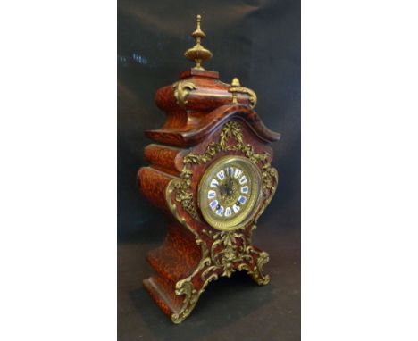 A 19th Century French Simulated Boulle and Gilt Metal Mounted Mantle Clock of shaped form, the brass dial with enamel Roman n