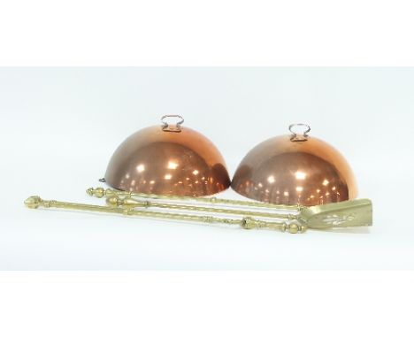A set of three brass fire irons, two copper food covers and a modern dome-topped mantel clock