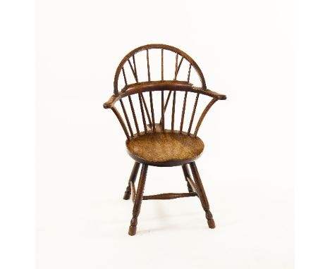 A rare 18th Century mahogany stick-back Windsor armchair, with outswept arms and circular seat on turned legs joined by a tur