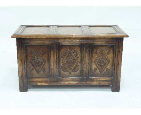 A carved oak chest and a circular tripod table