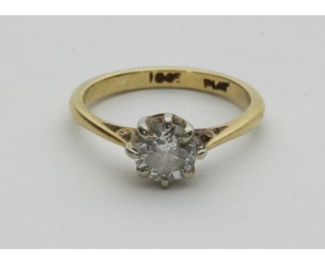 A diamond solitaire ring, claw set in platinum to an 18ct gold shank, ring size L½
