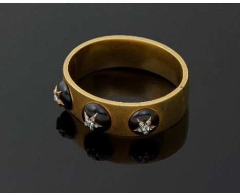 A Victorian gold cabochon garnet and diamond hinged bangle, circa 1850, the front decorated with three cabochon garnets each 