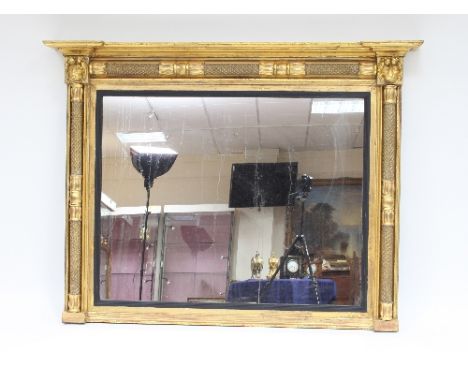A Regency giltwood and plaster overmantel mirror with lion mask capitals, the plate 92cm x 118cm