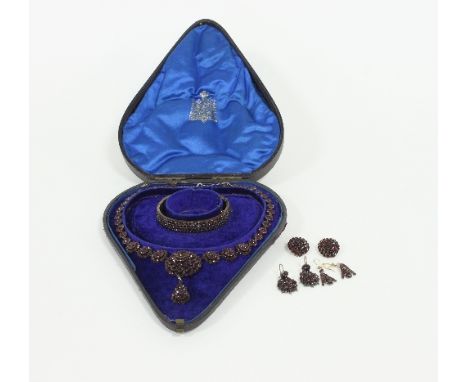 A garnet demi-parure comprising hinged bangle, pair of ear clips, pair of ear pendants and necklace, in fitted case for A Bor