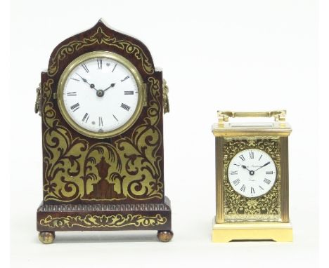 A 19th Century rosewood and brass inlaid mantel clock, the white enamel dial with Roman numerals, the ogee arch-top case with