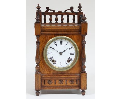 An Aesthetic movement oak mantel clock, with enamel dial and eight-day striking movement, 32cm high