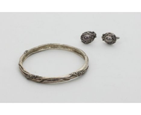 A pair of Georg Jensen ear studs, circa 1930s, numbered 34, of oval form with wreath type border and a Georg Jensen bangle, n