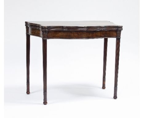 A George III style mahogany serpentine card table on turned reeded legs, 90cm wide Condition Report: 1930's, top veneer sligh