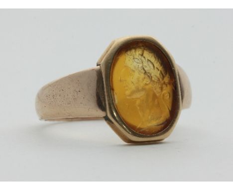 A hardstone intaglio ring, depicting a Roman in profile wearing a laurel wreath, set in unhallmarked yellow metal Condition R