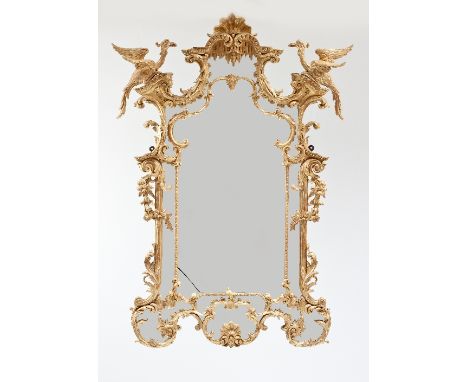A George III style carved and gilded wall mirror in the manner of Thomas Chippendale, the shell and rocaille cresting flanked