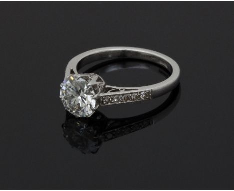 A diamond solitaire ring, the stone of approximately 1ct and with five small diamonds to each shoulder, ring size L½/see illu