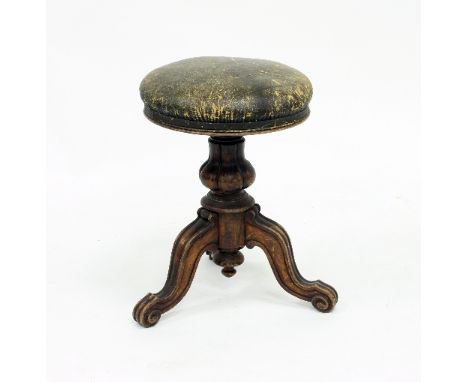 A Victorian walnut piano stool with upholstered adjustable top on a carved tripod support, 48.5cm high