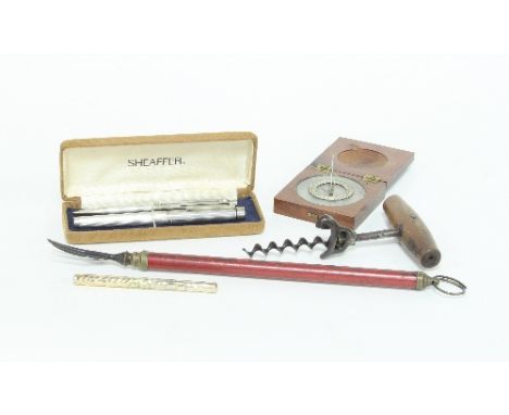 A travelling compass in a mahogany case, a telescopic toasting fork, a Victorian cork screw and a mercury thermometer in a pl