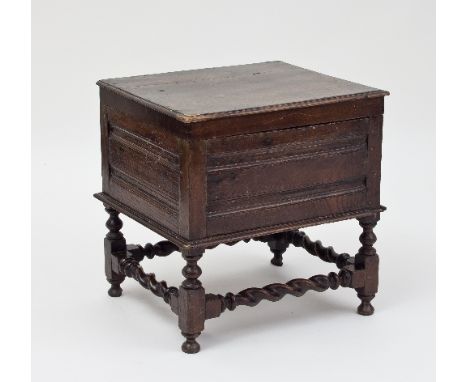 A 17th Century oak commode box with panelled sides, lifting lid and twist turned stand, 50cm wide/see illustration