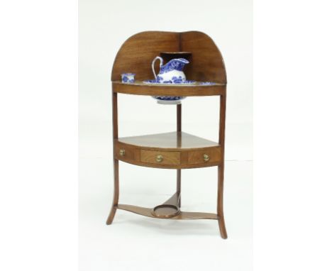 A Georgian mahogany corner washstand with drawer to the platform and fitted a jug, basin and toothbrush vases, 61cm wide