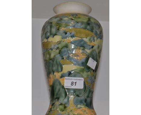 A Moorcroft type baluster shaped lamp base, decorated with a rural scene 