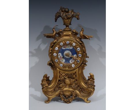 A French Rococo Revival porcelain mounted ormolu cartouche shaped mantel clock, 9cm dial inscribed ** a Paris, and decorated 