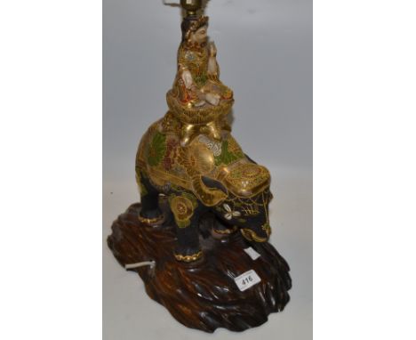 A Japanese Satsuma elephant lamp, hardwood stand, Meiji period