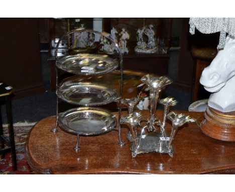 A Walker and Hall silver plated three tier cake stand; a silver plated epergne dedicated to a Mr J Rodgers on the occasion of