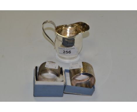 Silver- A silver helmet shaped cream jug, Chester 1911; Silver engine turned napkin ring, Chester 1898; Silver napkin ring, B