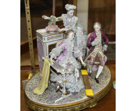 An early 20th century German figural lamp base of 18th century figures of title "carrying out past times"