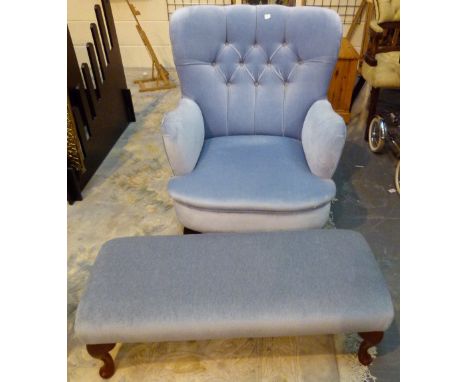 Pale blue upholstered button back arm chair and matching footstool