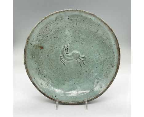 Thick earthenware bowl with horse in the middle in low-relief. Glazed in light blue and brown. Signed E. Deutch. Artist: Euge