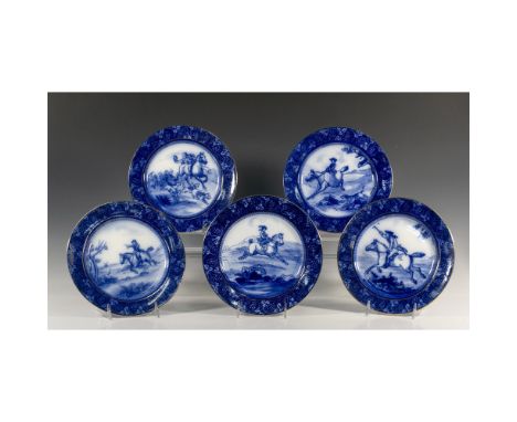 Cobalt blue plates with leaves and floral design on circumference with fox hunting motifs in center and gilt rim. Plate desig