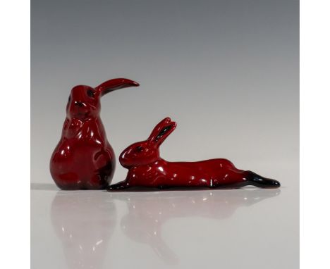 In the rich red flambe glaze, a pair of rabbits. First is sitting 1.5"L x 1.5"W x 2.75"H. Second is laying 4.25"L x 1"W x 1.7
