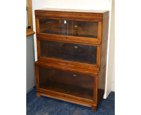 A Globe Wernicke oak stacking bookcase, with three sections and glazed dors, 117cm hih x 85cm wide x 29cm wide