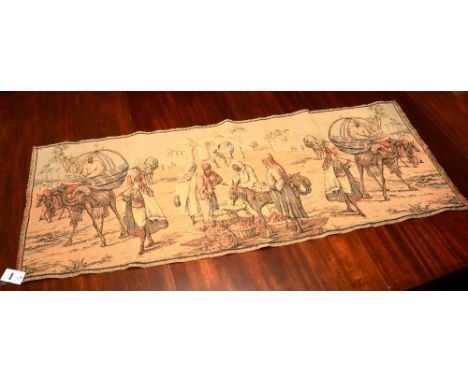 A tapestry panel depicting Bedouin traders, 30 x 139cm