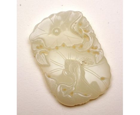 A Chinese jade style pendant depicting flowers and foliage, 5.5 x 4cm. CONDITION REPORT: Lot 211 - of white colour, stuck on 