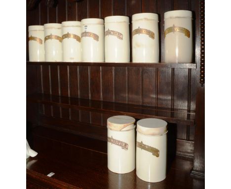 Nine matching vintage ceramic chemist jars, 25cm high
