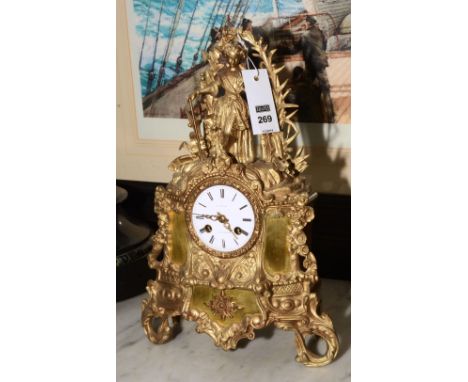 An early 20th century Continental gilt metal mantel clock, with white enamel circular dial, named to the dial D. Roman, Rotte