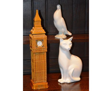 A Poole white ceramic cat figure, 29cm high, together with a nao bird figure, 22cm high, and a novelty ceramic whisky decante