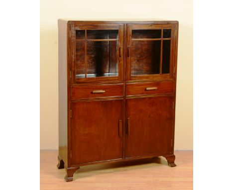 A stained mahogany bookcase, with two glazed doors enclosing a single shelf, above a cupboard base, ending in bracket support