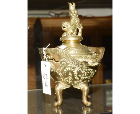 A Chinese brass censor, the lid with Kylin finial decorated with grotesque masks and dragons in foliage, 25cm high