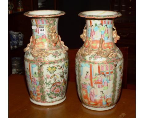 A pair of early 20th century Canton Famille Rose ceramic vases, of large proportions, chased with serpent and animal decorati