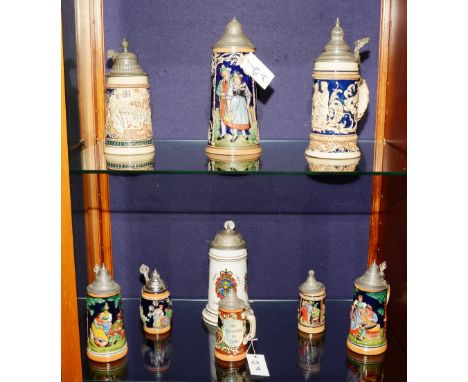 A quantity of ceramic beer steins, of different sizes, all with hinged lids (9)