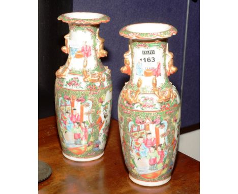 A pair of early 20th century Canton Famille Rose ceramic vases, chased with serpent and animal decoration, 26cm high CONDITIO